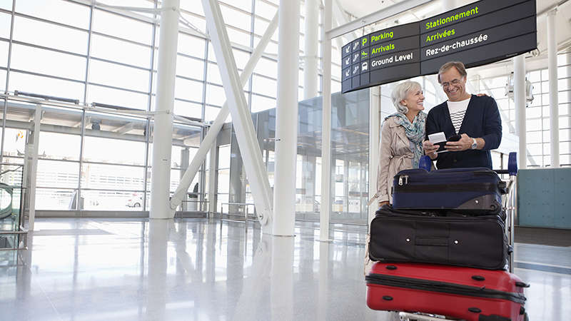 Senior couple with luggage at airport